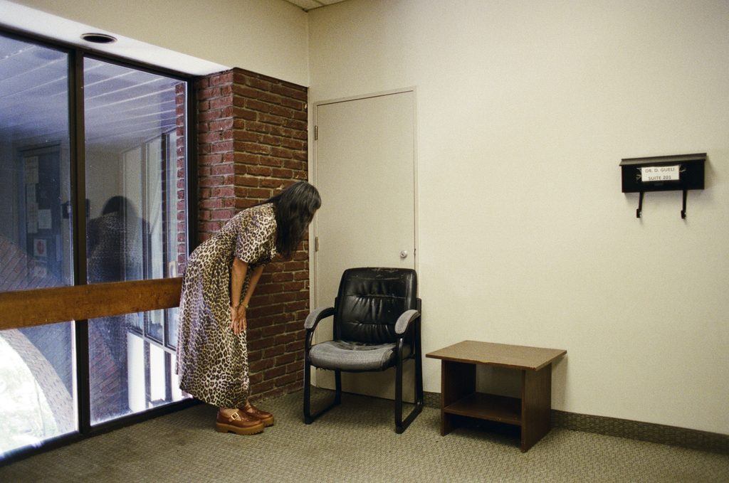 Thea Lim leaning over a chair in an office